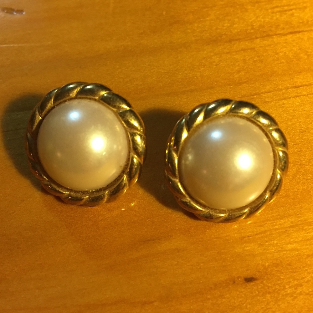 Gold and faux pearl stud earrings.